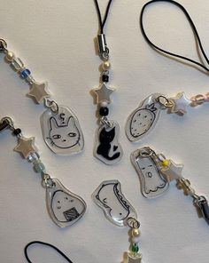 a group of necklaces that are on a white surface with black and white designs