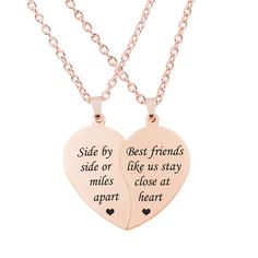 two heart shaped necklaces that say, side by side or best friends make us stay close at apart