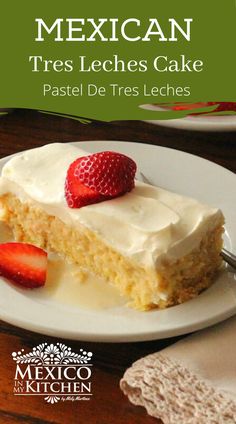 mexican tres leches cake with white frosting and strawberries on the plate next to it