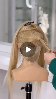 a wig being braided by a woman with long blonde hair