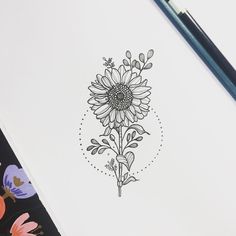 a drawing of a sunflower on paper next to a pencil and watercolor pens