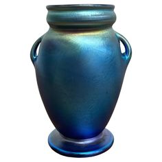 a shiny blue vase is shown against a white background