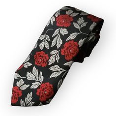 The Silk Black Red Floral Tie Set is the perfect addition to your formal wardrobe. Made from high quality silk, this elegant tie is adorned with a beautiful red and black floral pattern that is sure to make a statement at any formal occasion. The set includes a coordinating pocket square and cufflinks, completing the look with a touch of sophistication. 100% Silk Handmade Package Includes: Tie, Pocket Square & Cufflinks. Length: 59" Width: 3.34" Warm iron if needed Red Ties For Black-tie Events, Elegant Red Suit And Tie Accessories For Gift, Red Adjustable Tie For Formal Occasions, Adjustable Red Ties For Formal Occasions, Red Adjustable Formal Ties, Red Adjustable Ties For Formal Occasions, Elegant Red Suit And Tie Accessories For Black-tie Events, Elegant Red Suit And Tie Accessories For Formal Occasions, Elegant Red Suit And Tie Accessories For Formal Events