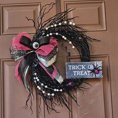 a trick or treat wreath on the front door