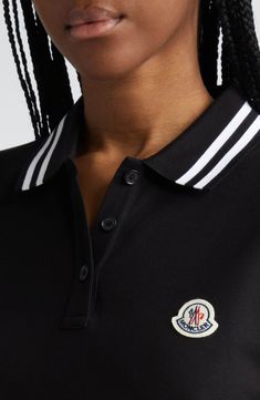 Cut in a slim fit from cotton piqué, this polo checks all the boxes of classic styling with its tipped collar and cuffs and the distinctive Moncler logo patch. Button half-placket Spread collar Short sleeves Side slits Drop-tail hem 100% cotton Dry clean or machine wash, dry flat Made in Turkey Designer Clothing Designer Black Polo Shirt With Ribbed Collar, Classic Black Top With Logo Patch, Classic Top With Polo Collar And Striped Cuffs, Classic Tops With Polo Collar And Striped Cuffs, Classic Tops With Striped Cuffs And Polo Collar, Designer Black Polo Shirt With Embroidered Logo, Classic Black Polo Shirt With Striped Collar, Classic Black Polo Shirt With Contrast Collar, Classic Black Polo Shirt With Ribbed Collar