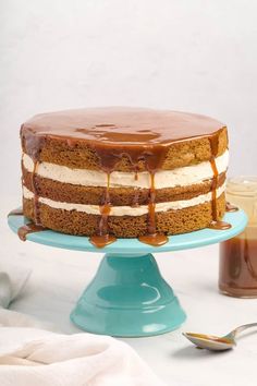 a cake sitting on top of a blue plate covered in frosting and caramel