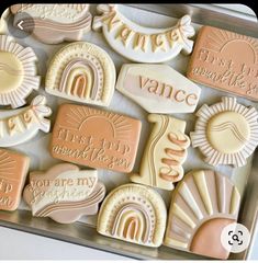 some cookies that are sitting on a tray with words and shapes around them in pastel colors