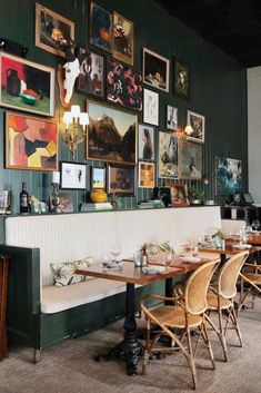 a restaurant with tables and pictures on the wall