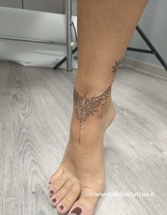 a woman's foot with a tattoo on it