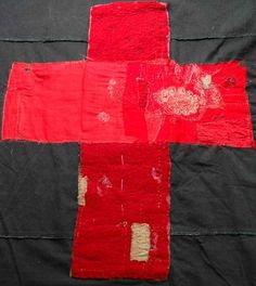 an old red cross on black fabric