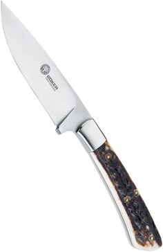 a knife that is sitting on top of a white surface with brown and black spots