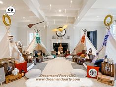 a living room filled with lots of pillows and teepees