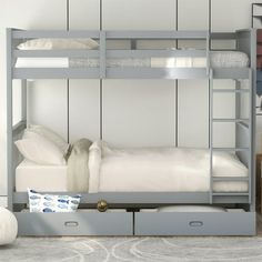 a bunk bed with two drawers underneath it and a white blanket on the bottom shelf