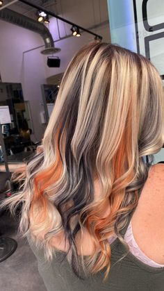 Platinum Blonde Hair With Black And Red Streaks, Blonde With Colored Extensions, Orange Blonde And Black Hair, Purple And Orange Hair Highlights, Blonde With Orange Underneath, Blonde With Colorful Highlights, Orange Black And Blonde Hair, Blonde With Orange Peekaboo, Quadrant Hair Color