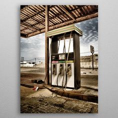 an old gas pump sitting on the side of a road