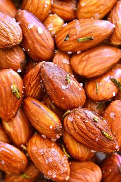 almonds with green leaves and water droplets on them are shown in this close up photo