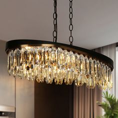 a chandelier hanging from a ceiling in a living room or dining room area