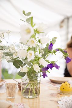 three vases filled with flowers sitting on top of a table