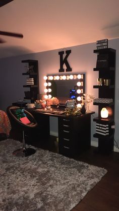 a bedroom with a vanity, mirror and lights