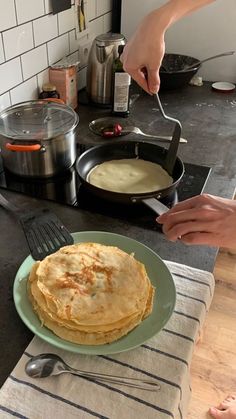 someone is cooking pancakes on the stove top