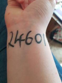 a person with a tattoo on their wrist that says,'4201'in black ink