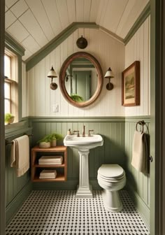 a white toilet sitting next to a sink in a bathroom under a round mirror on the wall