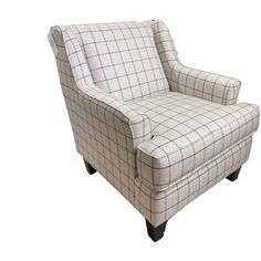 a chair that is sitting up against a white background with blue and gray checkered fabric