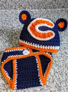 two crocheted beanies with bears on them are laying on the floor next to each other