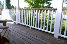 a wooden deck with two chairs on it