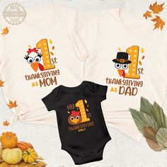 "These t-shirts are used to make the first Thanksgiving experience of the littlest members of the family special and unforgettable. They are generally produced in sizes that babies or newborns can wear. These types of t-shirts are often designed with text such as \"My First Thanksgiving\" and holiday-themed decorations. They may also offer personalization options such as adding baby or child names. This way, the family can record the new member's first Thanksgiving celebration and share the spec Thanksgiving Shirts For Mom And Dad, Mom And Baby Thanksgiving Shirts, Family Matching Cotton T-shirt For First Birthday, Matching Crew Neck T-shirt For First Birthday, Family Matching T-shirt For First Birthday, Funny Baby Thanksgiving Shirts, Baby First Thanksgiving Shirt, Customizable Family Matching T-shirt For First Birthday, Family Matching T-shirt With Name Print For First Birthday