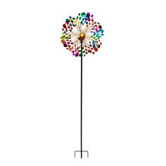 a multicolored flower on a metal pole with a white back ground behind it