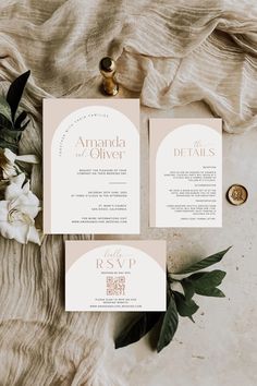 the wedding stationery is laid out on top of a table with flowers and greenery