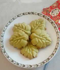 some food is on a white plate and next to a red napkin with an ornament