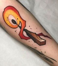 a tattoo on the leg of a person with an orange and red design on it