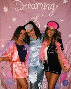 three beautiful women standing next to each other in front of a pink backdrop with the words dreaming on it