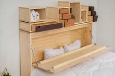 the bed is made up with wooden boxes and pillows