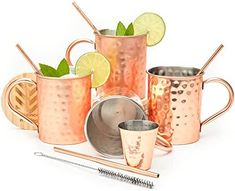 a group of copper mugs with lime slices and strawberries