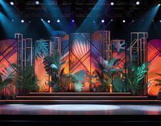 the stage is lit up with bright lights and palm trees in front of an audience