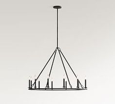 a black chandelier with candles hanging from it's center and four lights on each end