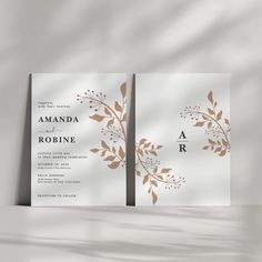 two wedding cards with gold leaves on them