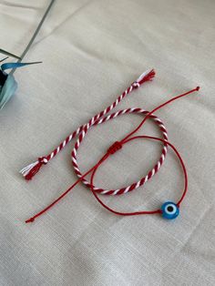 Red Bracelet With Martenitsa, Evil Eye Bracelet, Red String Bracelet, Adjustable Protect Bracelet. Handmade with love.  Set of 2 Bracelet, 1 piece of red-white cotton rope Martenitsa. Adjustable bracelet with 1 red rope and glass evil eye bead. You can wear the Red Bracelet With Martenitsa on your wrist by making a wish. Martenitsa is an old Bulgarian tradition. The Evil Eye symbolizes the jealous and envious look of others, which according to the popular belief, would have the power to cause va Adjustable Red Charm Bracelet, Adjustable Red Round Charm Bracelet, Adjustable Round Red Charm Bracelet, Red Round Beads Bracelet As Gift, Handmade Adjustable Red Wristband, Handmade Red Adjustable Wristband, Adjustable Red Friendship Bracelet As Gift, Red Round Jewelry For Friendship, Round Red Jewelry For Friendship