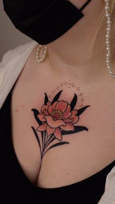 a woman with a flower tattoo on her chest