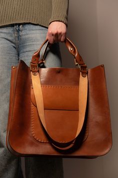 We want to make your life as comfortable as it possible!  That's why we've made a leather designer luxury bag (shopper) by hands with a big love and passion ♥️ ⚒ This handcrafted shopper-bag is made from premium Italian leather in rich brown color. It features a magnet and straps, combining style and practicality.  🙌The bag's voluminous design allows you to fit all your belongings while remaining stylish. ☑️ Each bag is unique, making it a one-of-a-kind accessory. About the Bag: *Size: 36x32x10 Luxury Bags With Grained Texture For Daily Use, Luxury Artisan Bags With Leather Lining, Luxury Leather Tote Pouch, Luxury Artisan Bags For Everyday, Luxury Functional Bags With Leather Handles, Luxury Everyday Bags In Recycled Leather, Luxury Modern Bags With Suede Lining, Luxury Brown Shoulder Bag With Canvas Lining, Luxury Functional Bags With Leather Backing