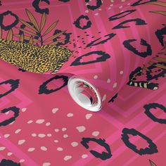 a pink wallpaper with black and gold leopard print on it's side, next to a white roll of tape