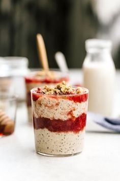 two desserts are sitting on a table next to milk