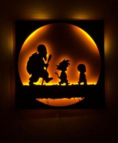 the silhouettes of three children on a bridge in front of an orange moon,