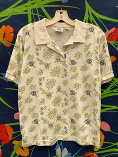 vintage floral button up polo shirt Spring Collared Printed T-shirt, Collared Polo Shirt With Buttons For Summer, Spring Short Sleeve Polo Shirt, Cotton Floral Print Collared Camp Shirt, Funky Button Up Shirt Outfit, Vintage Patterned Cotton Camp Shirt, Spring Polo Collar Top With Button Closure, Spring Cotton Camp Shirt With Floral Print, Summer Graphic Print Collared Polo Shirt