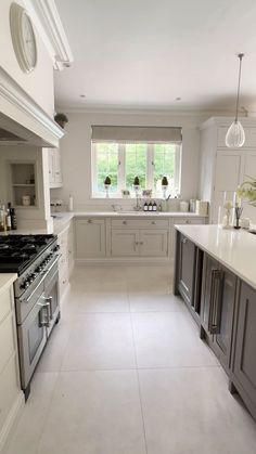 a large kitchen with an oven, stove and sink