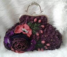 a purse with flowers on it sitting on top of a white furnishing floor