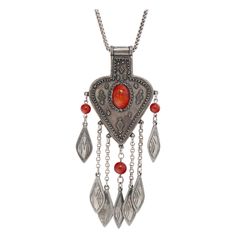 This incredible vintage Ben Amun statement necklace was designed and created in the 1980s and is such a collectible piece, featuring faux Carnelian stone surrounded by tribal motif's. Signed on verso. Designer Isaac Manevitz created the Ben Amun brand in New York over 30 years ago. Starting in the early ’80s, Manevitz helped to pioneer the statement jewelry trend, which led to Ben Amun's inclusion in top fashion magazines, on runways, and in the collections of fashionistas like Jacqueline Kennedy Onassis. The famous Ben Amun bracelet, once worn by Jackie O', sold at Sotheby's for $29,000. - Pendant measures 5.5" - Chain length is 30" - Circa 1980 - Faux Aged Silvertone - Faux Carnelian cabochon and beads - Signed Ben Amun on verso - Clasp closure Vintage Amber Necklaces For Festivals, Silver Carnelian Bohemian Necklace, Silver Carnelian Bohemian Necklaces, Bohemian Silver Carnelian Necklaces, Collectible Bohemian Amber Jewelry, Bohemian Amber Jewelry With Large Pendant, Red Bohemian Jewelry For Collectors, Bohemian Natural Stones Collectible Necklaces, Red Bohemian Collectible Jewelry